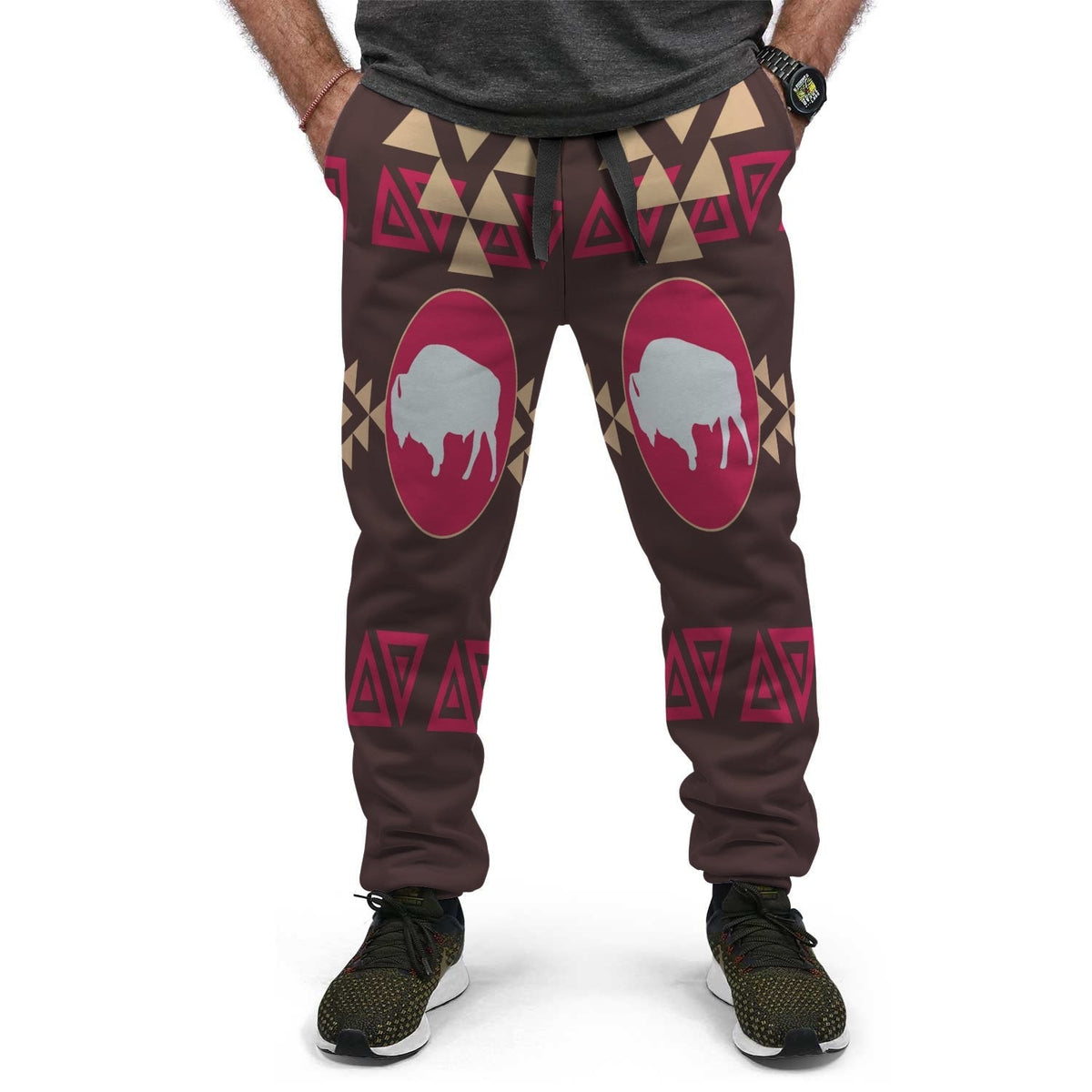 Brown Native joggers with pink oval bison and geometric band at waistband, two-leg view