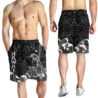Men's black Hawaiian print swim shorts, front view with tribal figure, waves, and ALOHA text