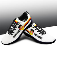 White top sneakers with dark blue sole, Germany logo on side, eagle crest and stripes