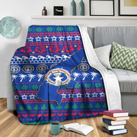 Blue North Mariana Islands Christmas blanket draped over couch with map, wreath and holiday stripes
