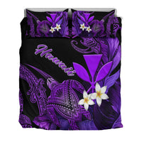 Top view of black duvet cover with purple turtle, plumeria flowers, and two pillows