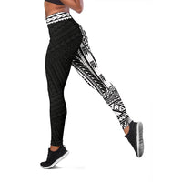 Side view black leggings with white geometric and arrow-like tribal pattern panel