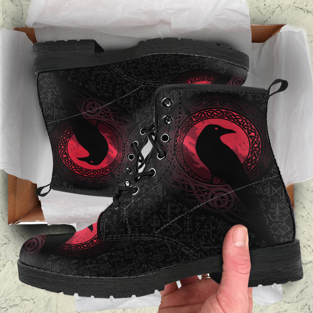 Black boots with red raven print and Nordic symbols, in shipping box