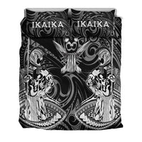 Front view of black/white duvet set with tassel emblem and two patterned pillows
