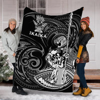 Black Ikaika warrior blanket with tribal face and feather emblem, IKAIKA lettering