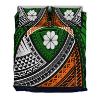 Tribal bedding set with two pillow shams, white flower motifs, green center panel and orange band.