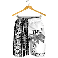 White men’s shorts on hanger, black tapa side panel with Fiji palm tree graphic