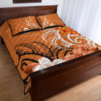 Orange quilt and pillow set with tropical scrolls and floral prints on a bed