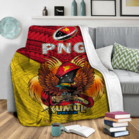 Kumul Pride blanket draped over sofa, red “PNG” banner and eagle crest on yellow base