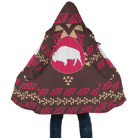 Close-up of hooded cloak front, brown with bison graphic and geometric trim