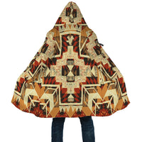 Front close-up of hooded cloak: geometric native pattern with hood ties, beige and dark accents