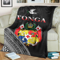 Black Tonga premium blanket on sofa, large crest with dove and geometric stripe