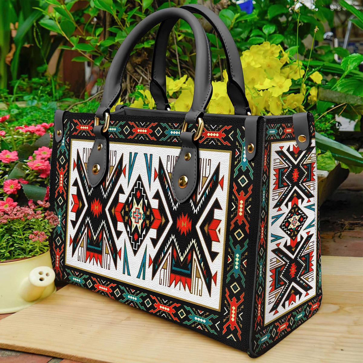 Colorful tribal patterned leather tote with black handles and gold snap details