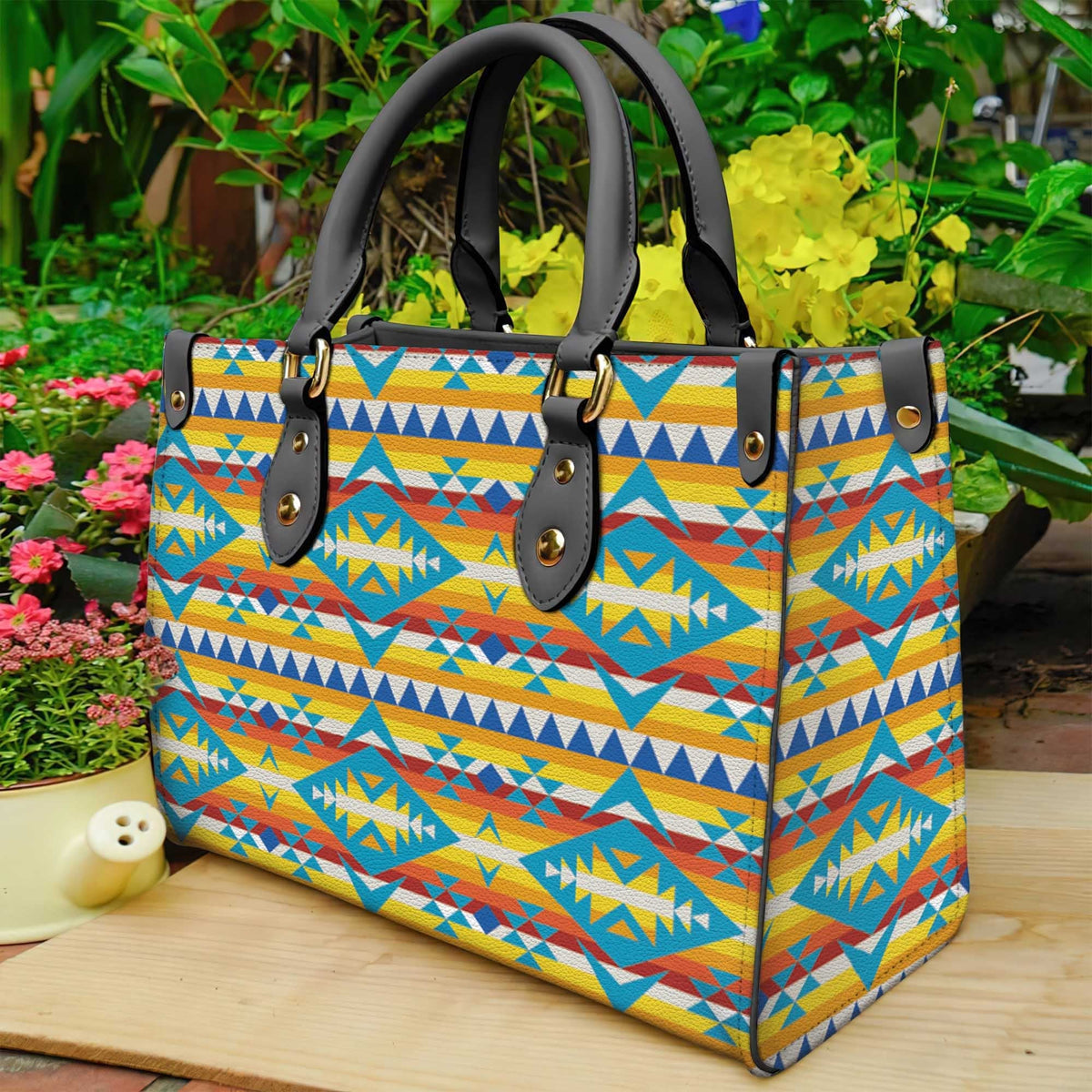 Multicolor geometric patterned leather tote with black handles and studded straps