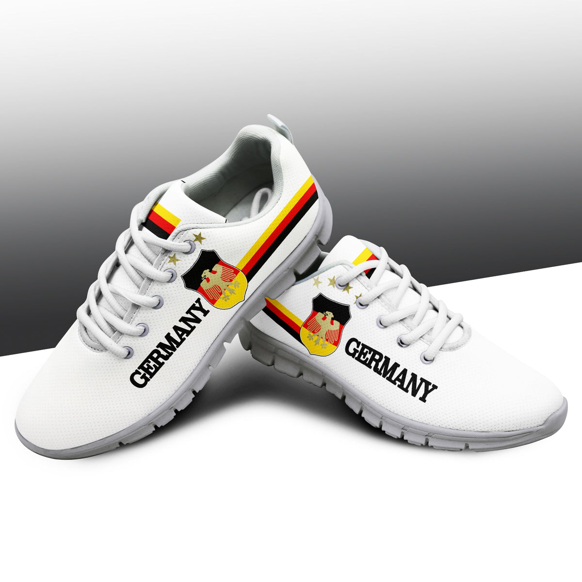 White sneakers with light gray sole, Germany text, eagle crest badge and flag stripe