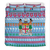 Blue duvet and pillowcases with central crest, dancers in green skirts, and red flower stripe