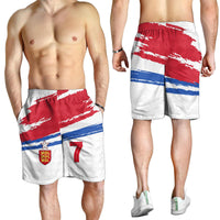 England football shorts worn by men; elastic waistband, crest and “7” on striped pattern