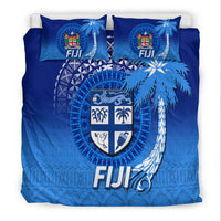 Fiji blue bedding set, close view of crest shield with tapa-style patterns on duvet and pillows