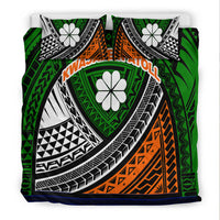 Close view of green tribal bedding set: black-and-white curved patterns, orange panel, blue edge.