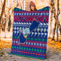 Blue holiday Guam Christmas blanket held outdoors with Guam map and festive border