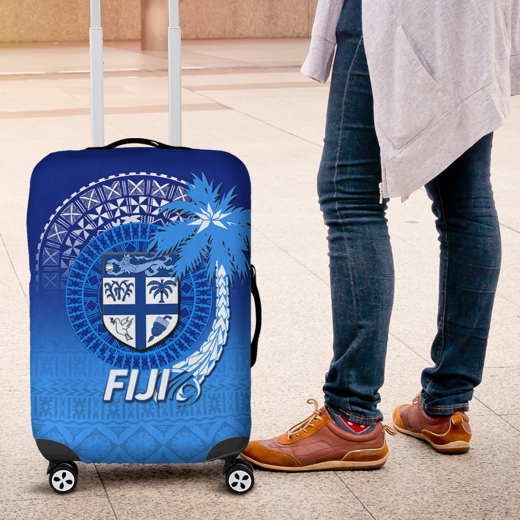 Blue Fiji luggage cover with shield crest and repeating tribal motifs, side view