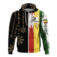 Front view Ethiopia zip hoodie, black with aztec dots and multicolor flag stripe