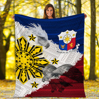 Philippines eagle blanket held up outdoors, blue top, red bottom, yellow sunburst emblem