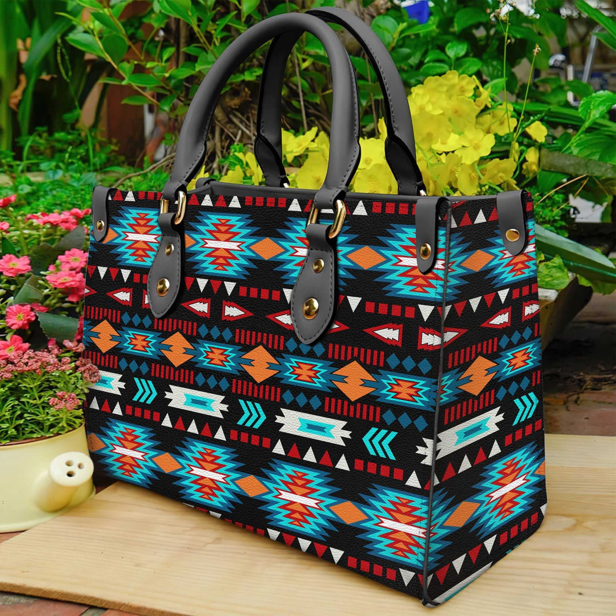 Multicolor native-pattern leather tote bag with dark handles and front buckle straps