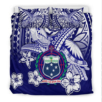Blue duvet cover with turtle and floral Polynesian patterns, shield crest emblem
