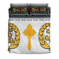 Eritrea Tibeb bedding set: white duvet with golden birds and cross, two “Your Text” pillows.