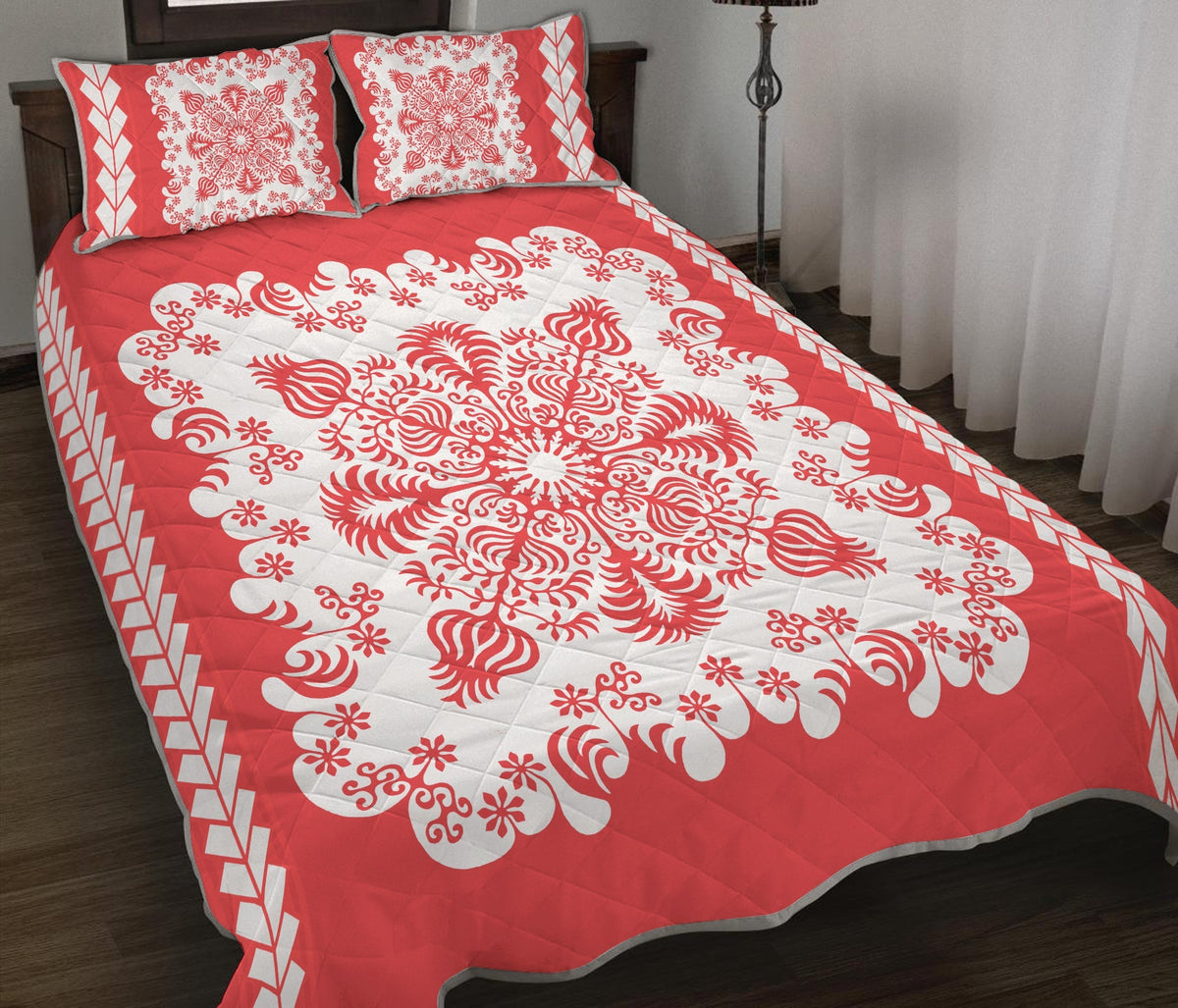 Red quilt with large white ornamental rosette motifs and diamond-edge trim; includes two shams