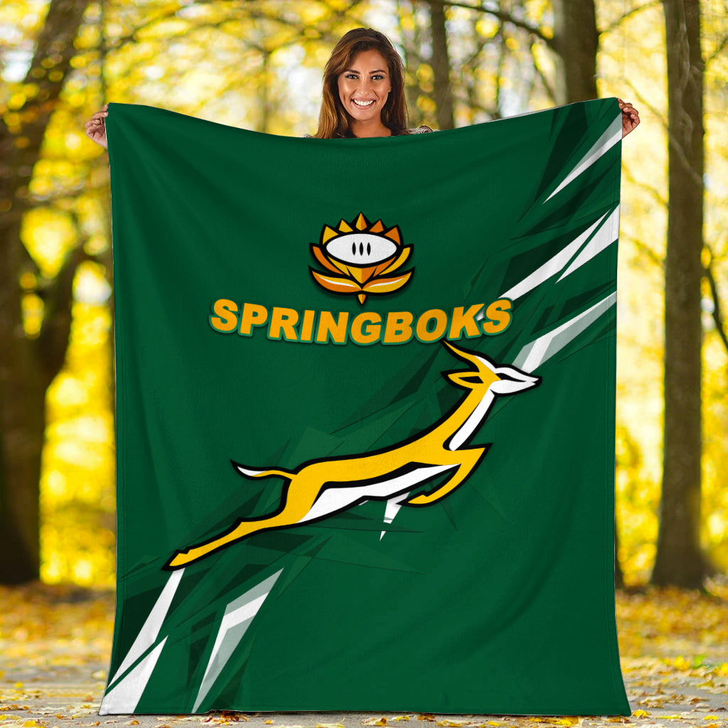 Green Springboks blanket with logo text and leaping graphic, held outdoors