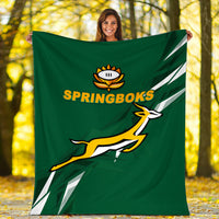Green Springboks blanket with logo text and leaping graphic, held outdoors