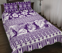 Purple and white quilt with palm-leaf, tribal motifs, and border zigzag; pillow top