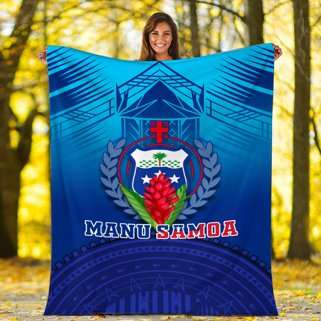 Blue Manu Samoa blanket held outdoors, crest emblem and “MANU SAMOA” text in red and white