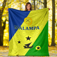 Malampa flag blanket held up outdoors, bold “MALAMPA” text over blue, lime-yellow, and green