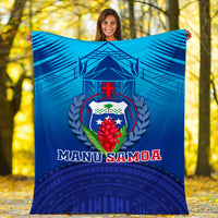 Blue Manu Samoa blanket close view, tropical shield crest and geometric patterned base
