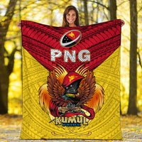 Kumul Pride blanket held up outdoors—yellow field, red band, eagle with “PNG”