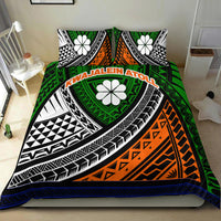 Green tribal bedding set on bed with two pillows; bold orange curve, black geometric bands