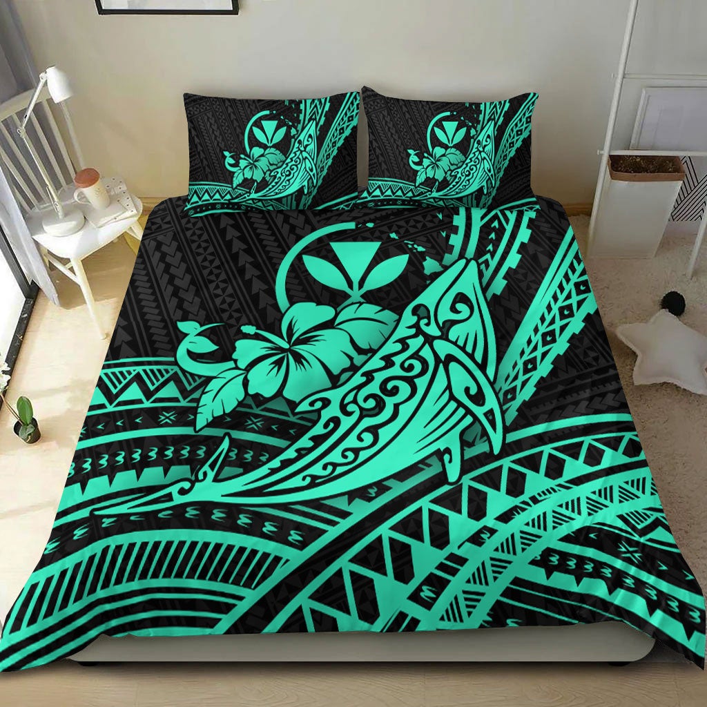 Turquoise & black Hawaiian bedding set on bed with humpback whale, hibiscus tribal print, two pillows