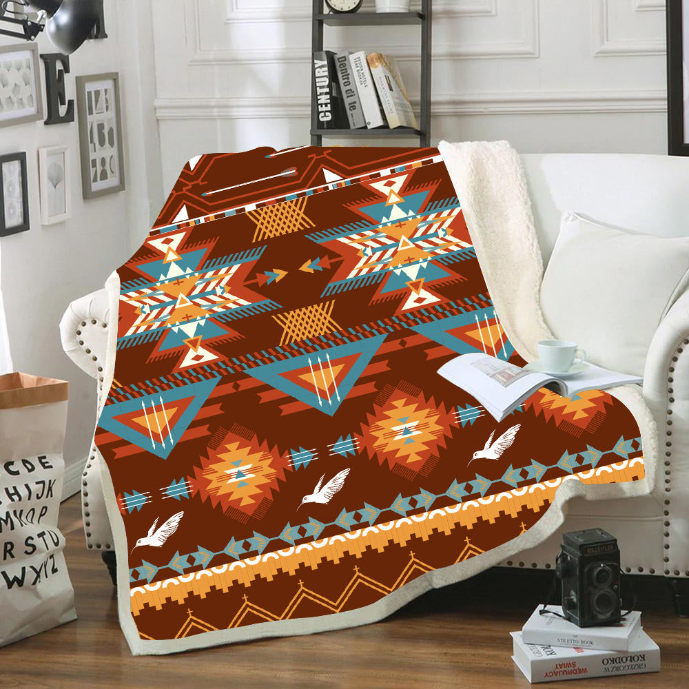 Multicolor brown blanket with tribal bird pattern, folded over chair arm