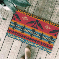 Multicolor geometric doormat with red center, blue and tan bands, dark edging
