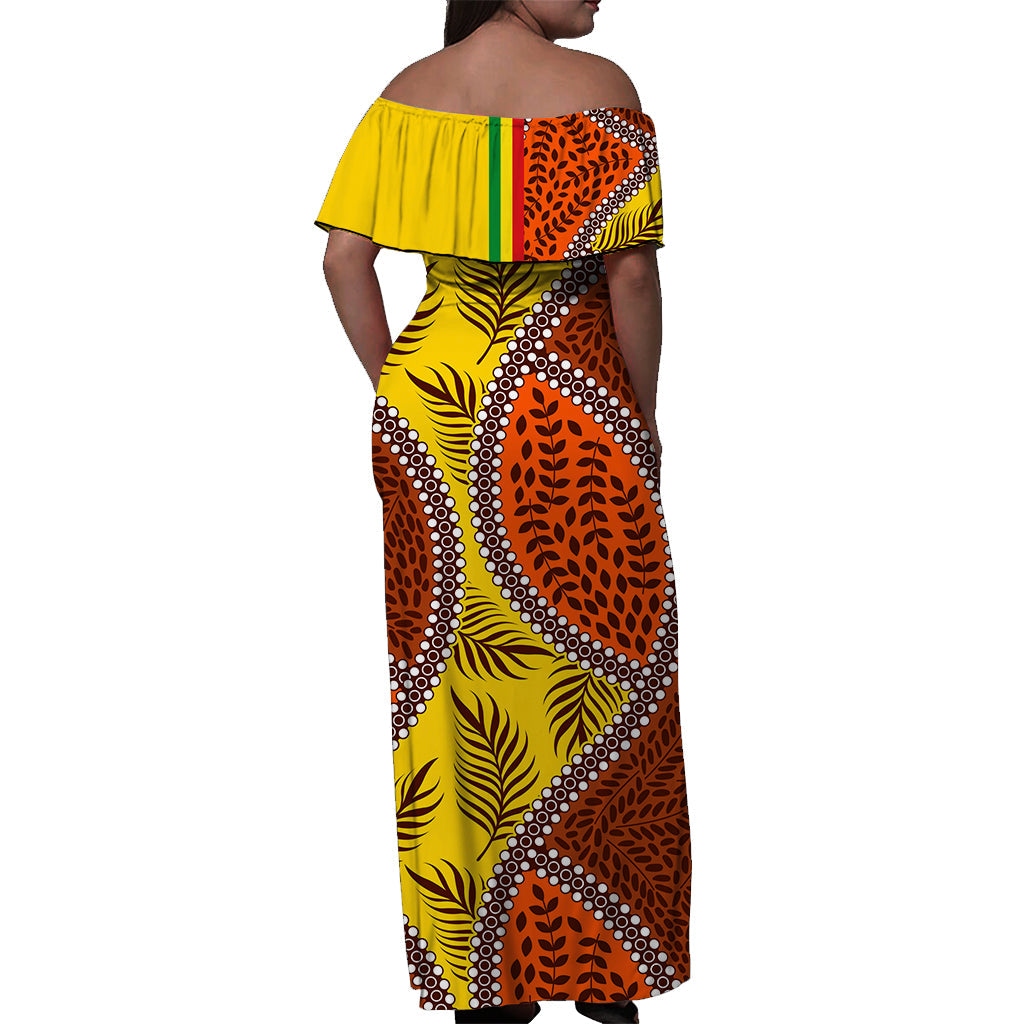Yellow off-shoulder maxi dress, back view, orange leaf pattern with dot trim