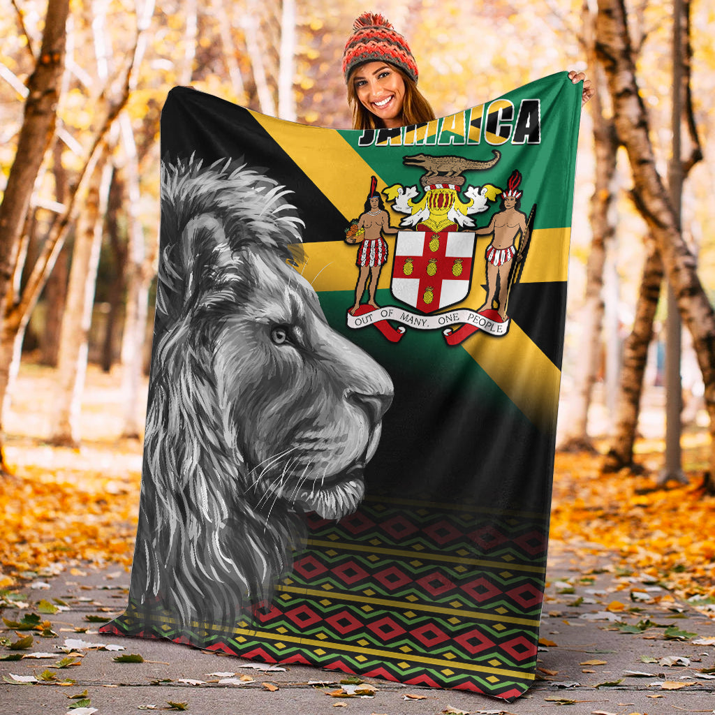 Black blanket showing Jamaica crest, roaring lion face, and multicolor geometric border
