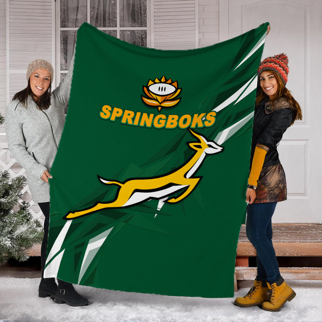 Green Springboks blanket held by two people, showing logo emblem and leaping graphic