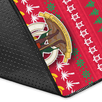 Close-up of red rug with black dotted edge binding and holiday motif soldier emblem