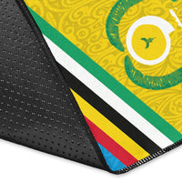 Close-up of Torba flag area rug edge, black backing with striped border and stitching