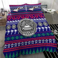 Blue bedding set close-up: Samoa seal medallion over holiday patterns, palms and pine trees