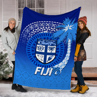 Blue Fiji tapa tribal blanket displayed wide, shield emblem and “Fiji” text visible