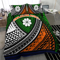Green tribal bedding set with orange zigzag section, white flowers, black-and-white arches, blue border.